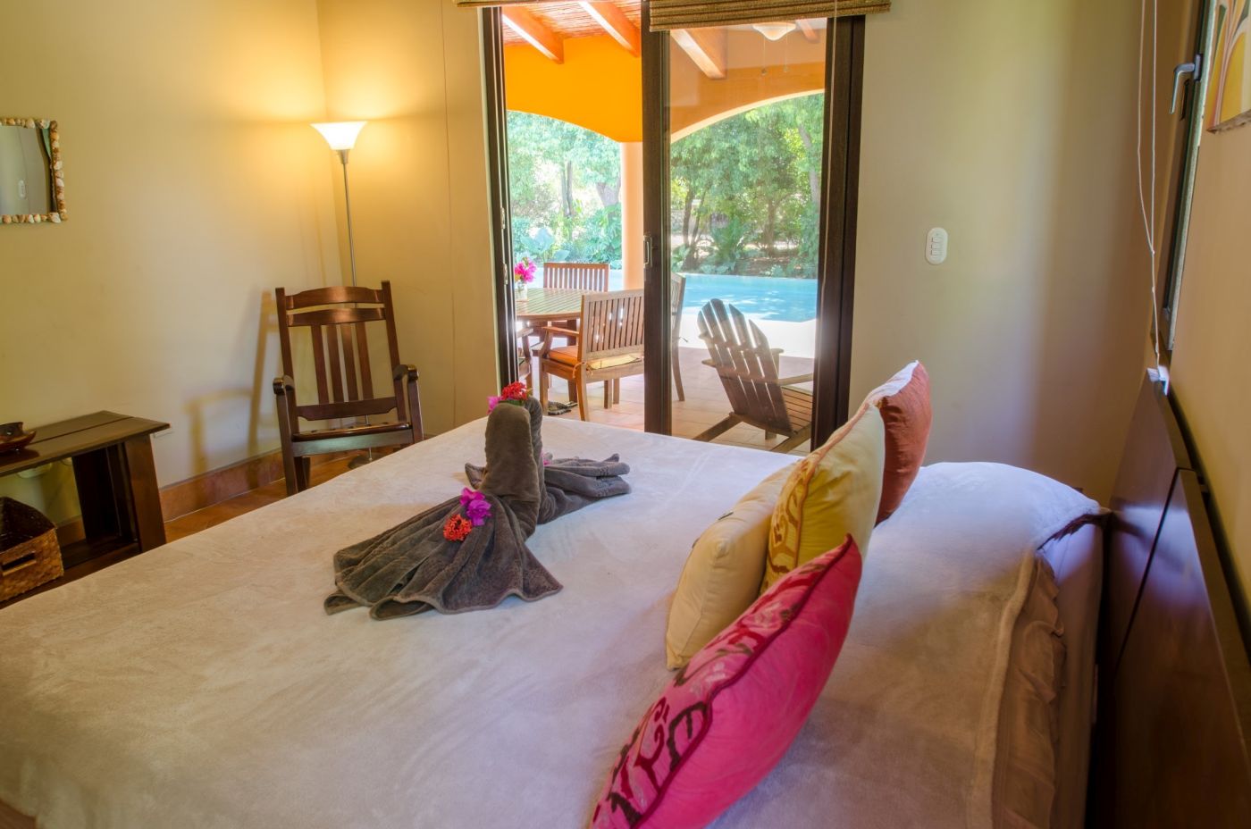 Bright bedroom offering a view toward the pool
